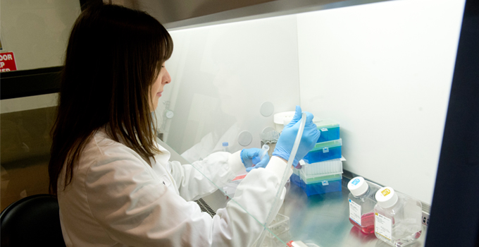 A technician works in OICR pathology lab