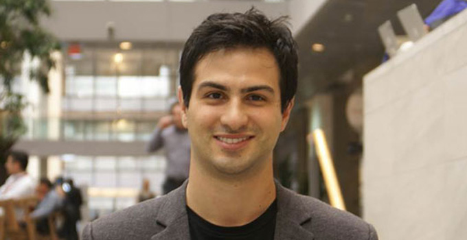 Dr. Marc Fume poses for a photo in an atrium