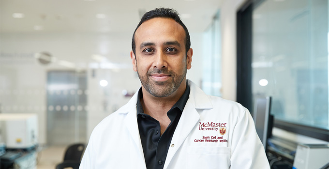 Dr. Mick Bhatia poses for a photo in his lab.