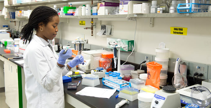 A lab technician works to extract DNA from a sample in OICR's Genomics lab.