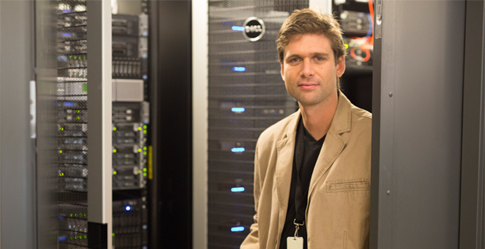 Dr. Benjamin Haibe-Kains, Senior Scientist at the Princess Margaret Cancer Centre and OICR Associate poses for a photo in a data centre.